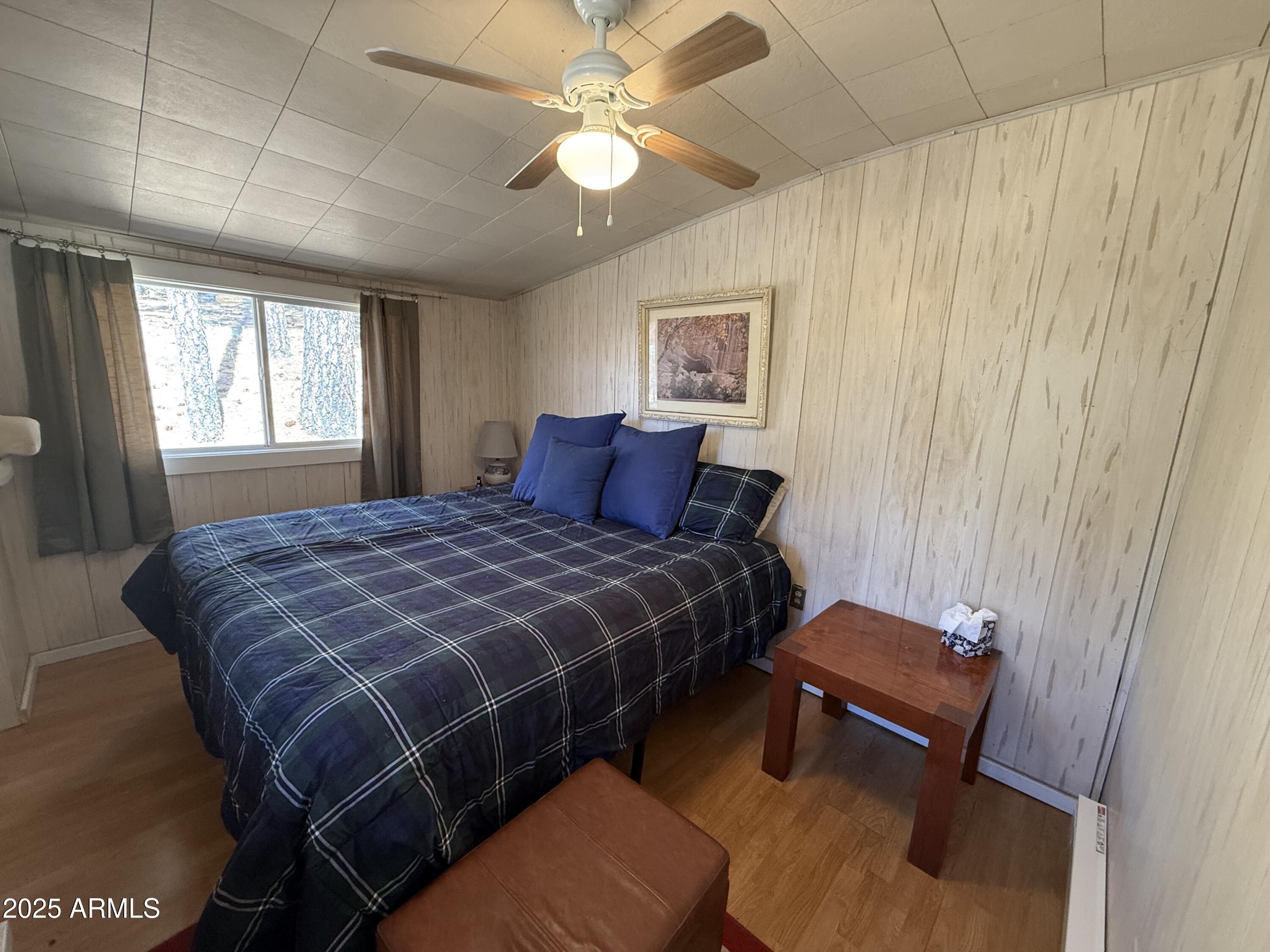 6937 Torpedo Road Crown King, AZ 86343 - Photo 4 of 23 a bedroom with a bed and a chandelier