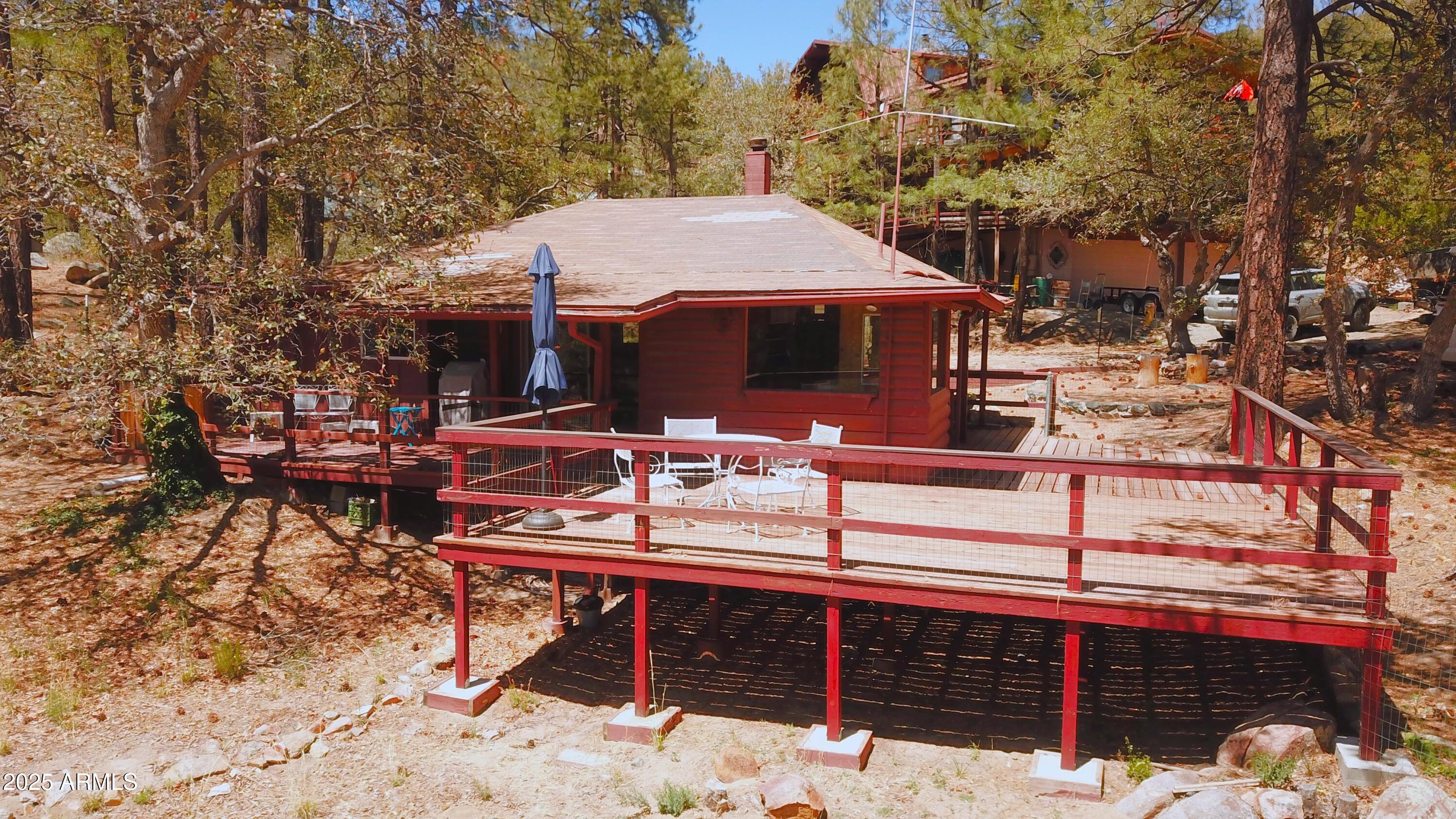 6937 Torpedo Road Crown King, AZ 86343 - Photo 8 of 23 a view of a chairs and table in the back yard of the house