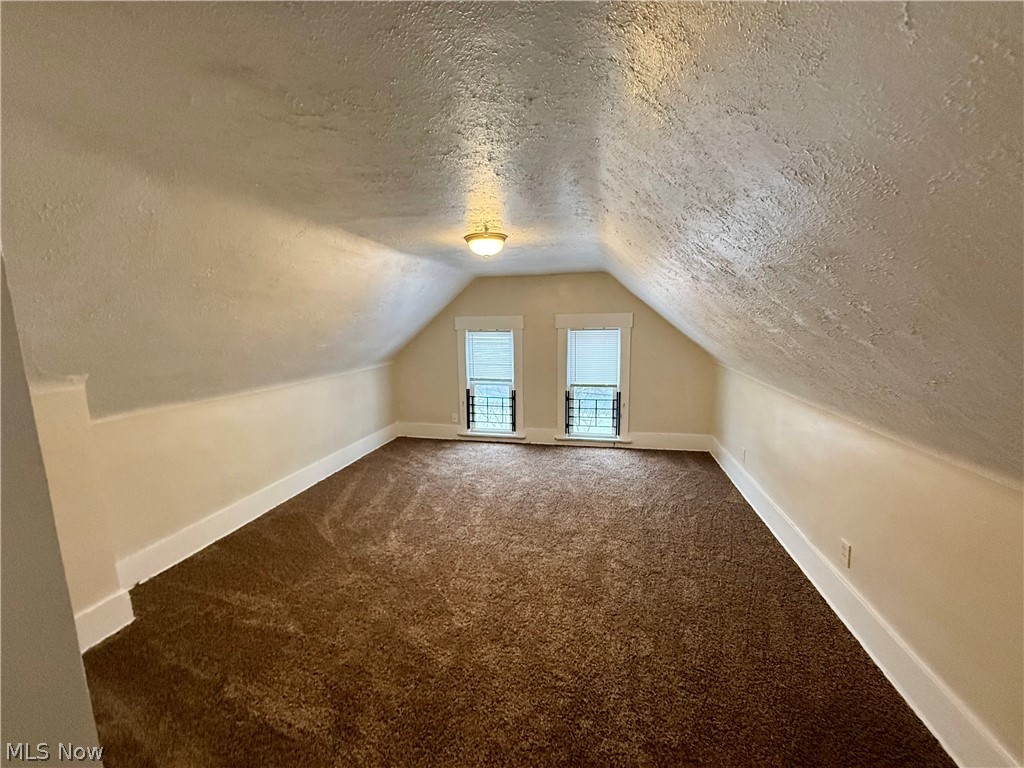 39 North Balch Street Akron, OH 44303 - Photo 3 of 19 Additional living space featuring dark carpet and a textured ceiling