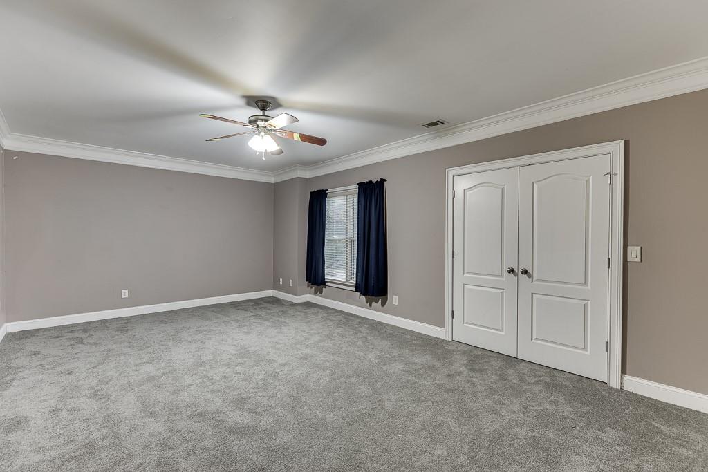 940 Chateau Forest Road Hoschton, GA 30548 - Photo 69 of 87 a view of an empty room with a ceiling fan