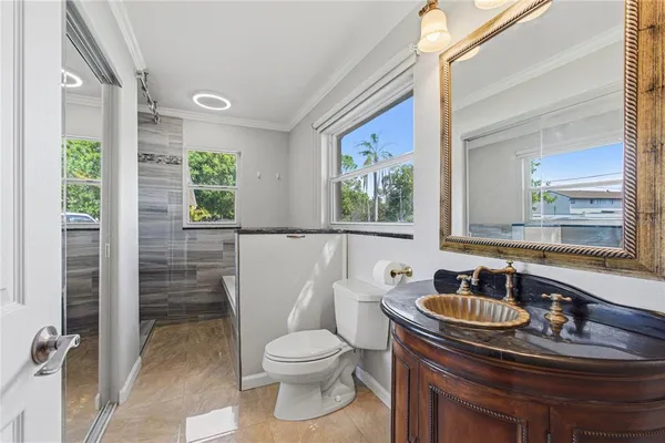 a sink and a toilet sitting next to a window