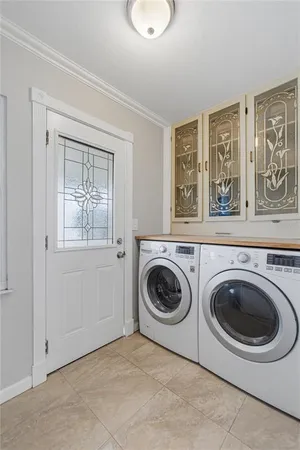 a utility room with sink dryer and washer