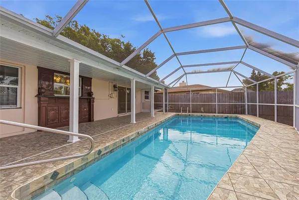 a view of a backyard with a swimming pool