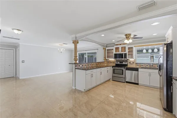 a large kitchen with a large counter top appliances and cabinets