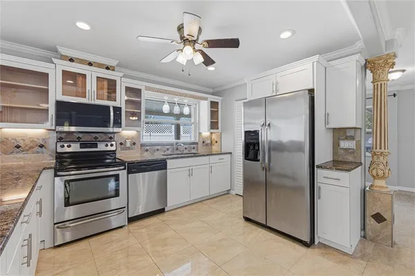 a kitchen with stainless steel appliances granite countertop a stove and a refrigerator