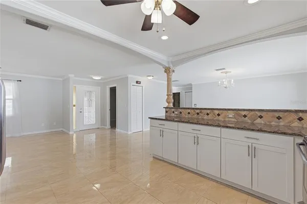 a kitchen with granite countertop a sink and a refrigerator