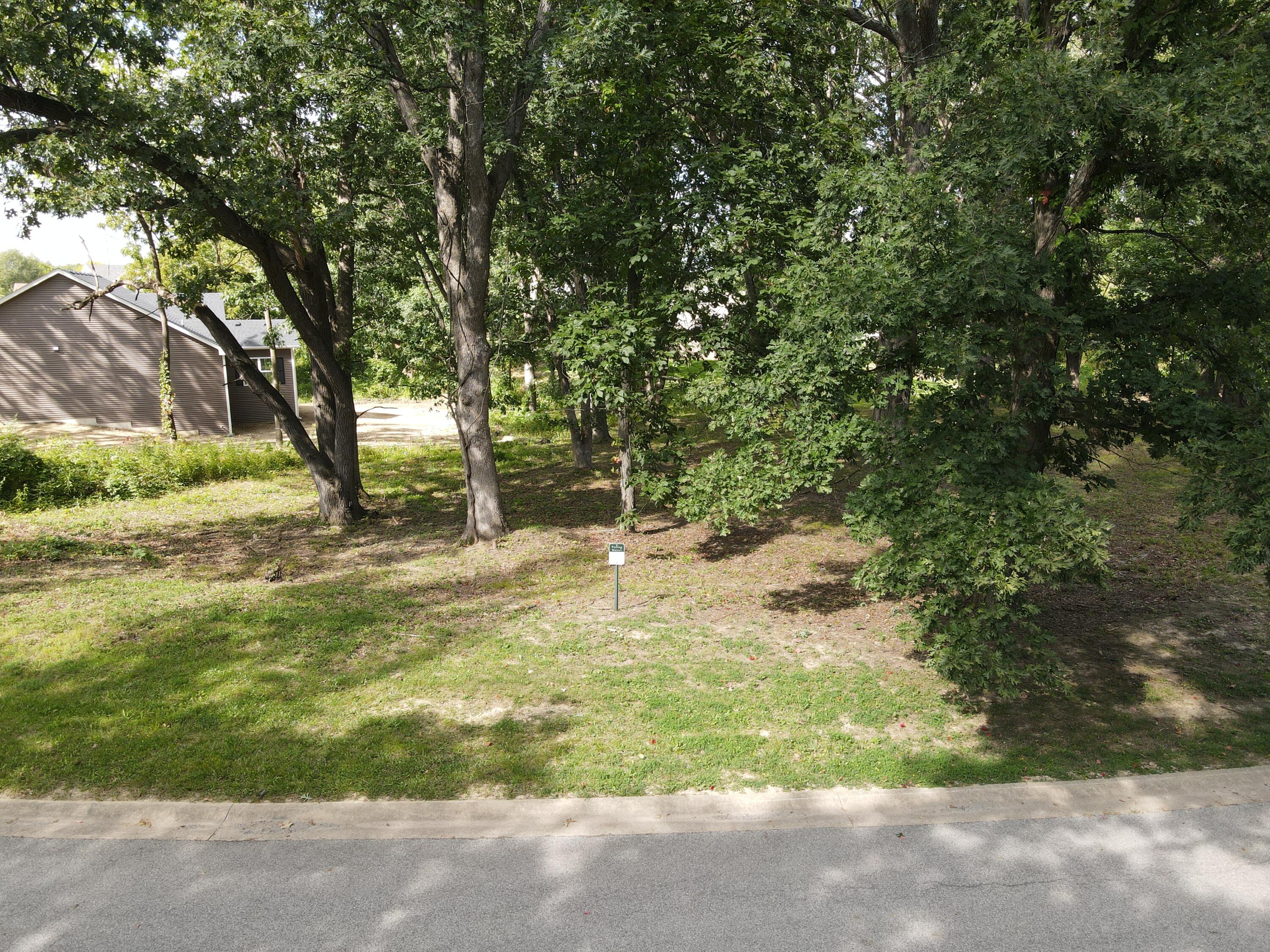723 Druim Trail Crown Point, IN 46307 - Photo 2 of 8 a backyard of a house with a yard and large trees