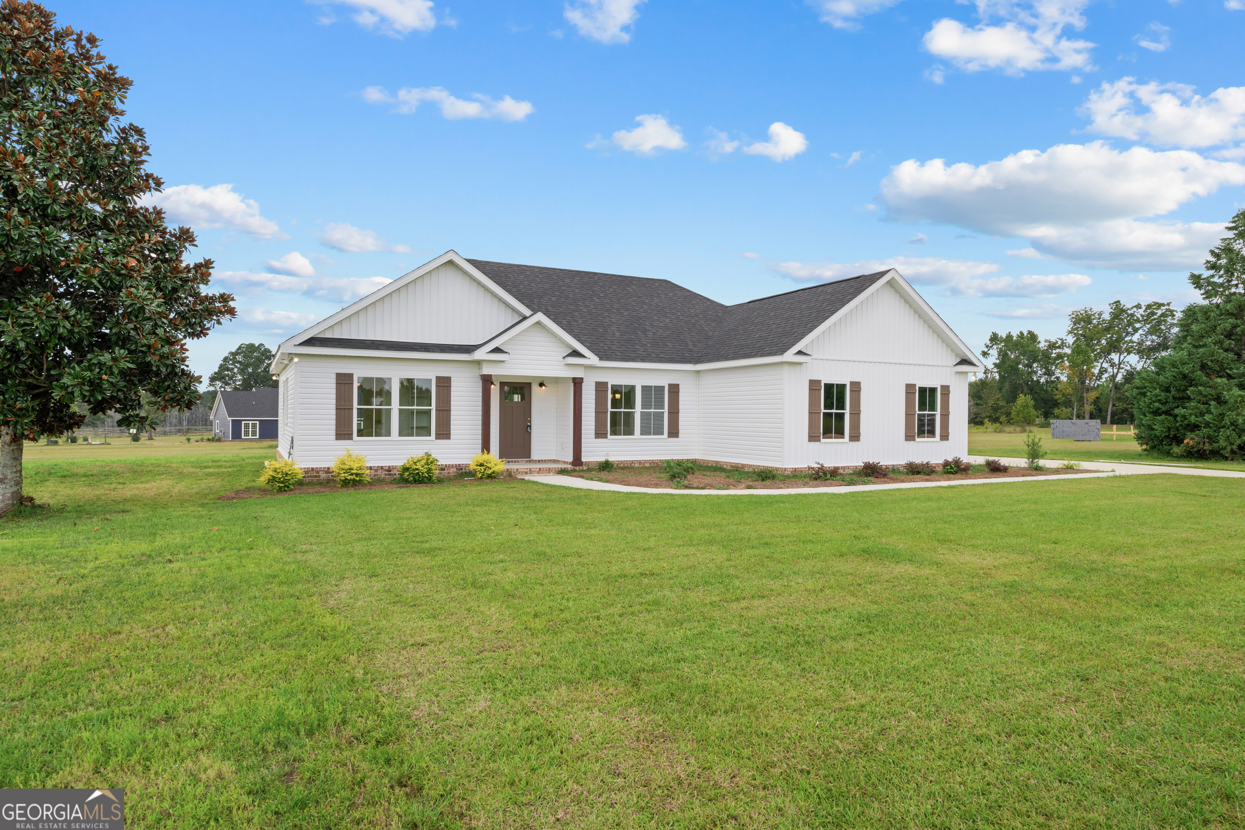 543 Jack Kennedy Road Statesboro, GA 30458 - Photo 1 of 35 a front view of a house with a garden