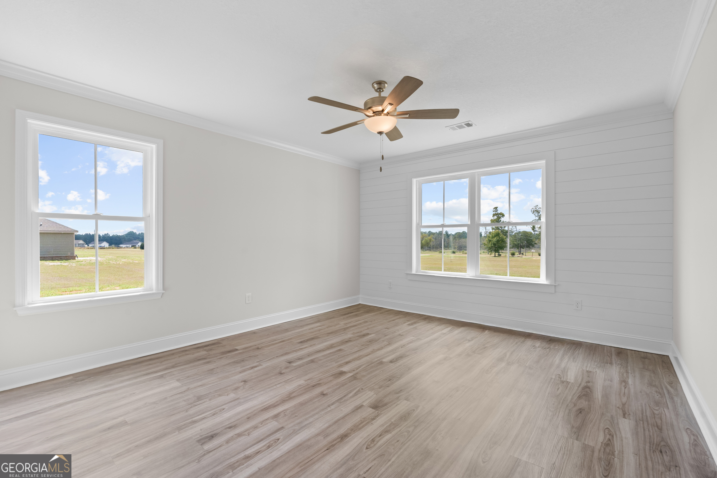 543 Jack Kennedy Road Statesboro, GA 30458 - Photo 12 of 35 a view of an empty room with wooden floor and a window