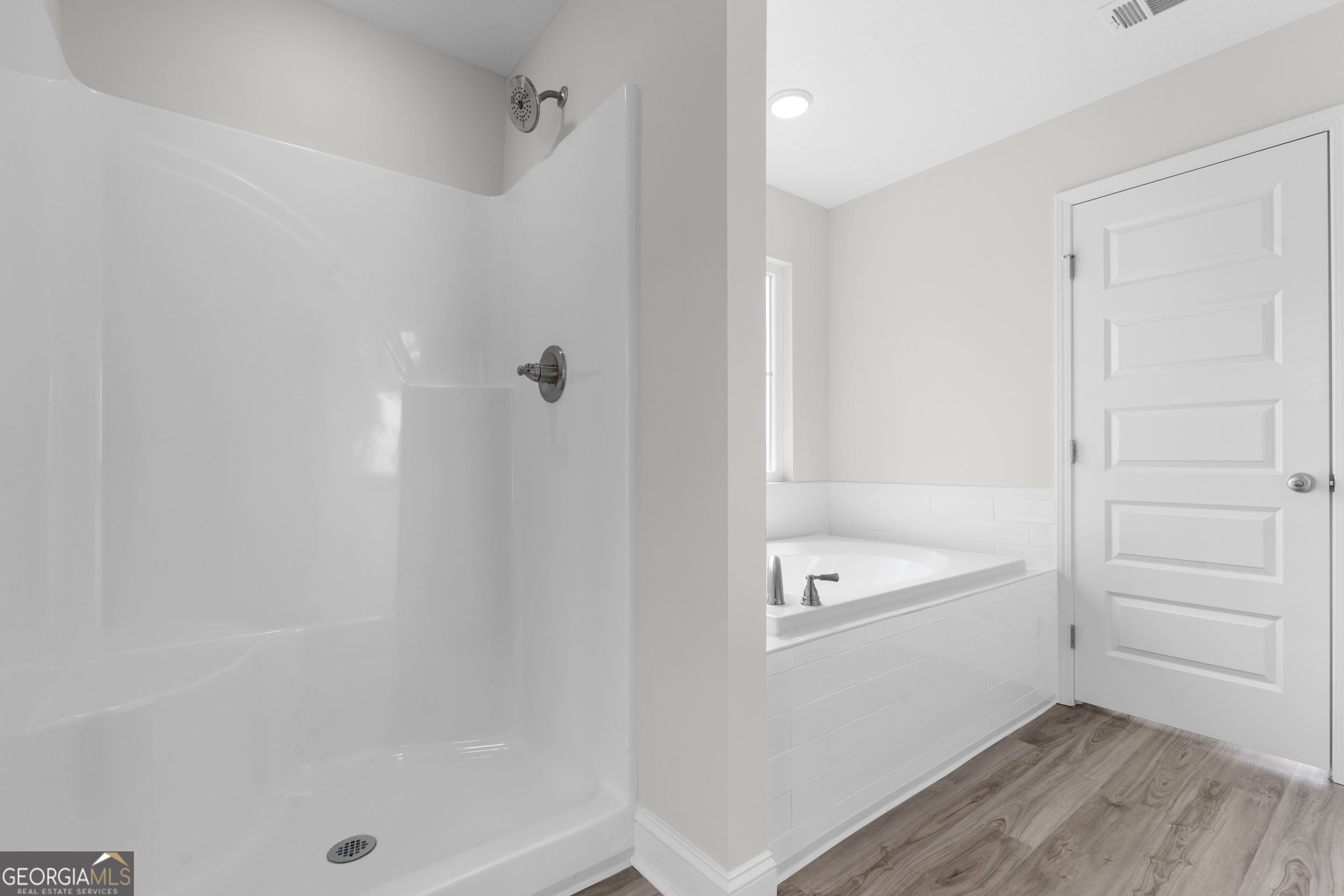 543 Jack Kennedy Road Statesboro, GA 30458 - Photo 13 of 35 a bathroom with a tub a sink and a shower