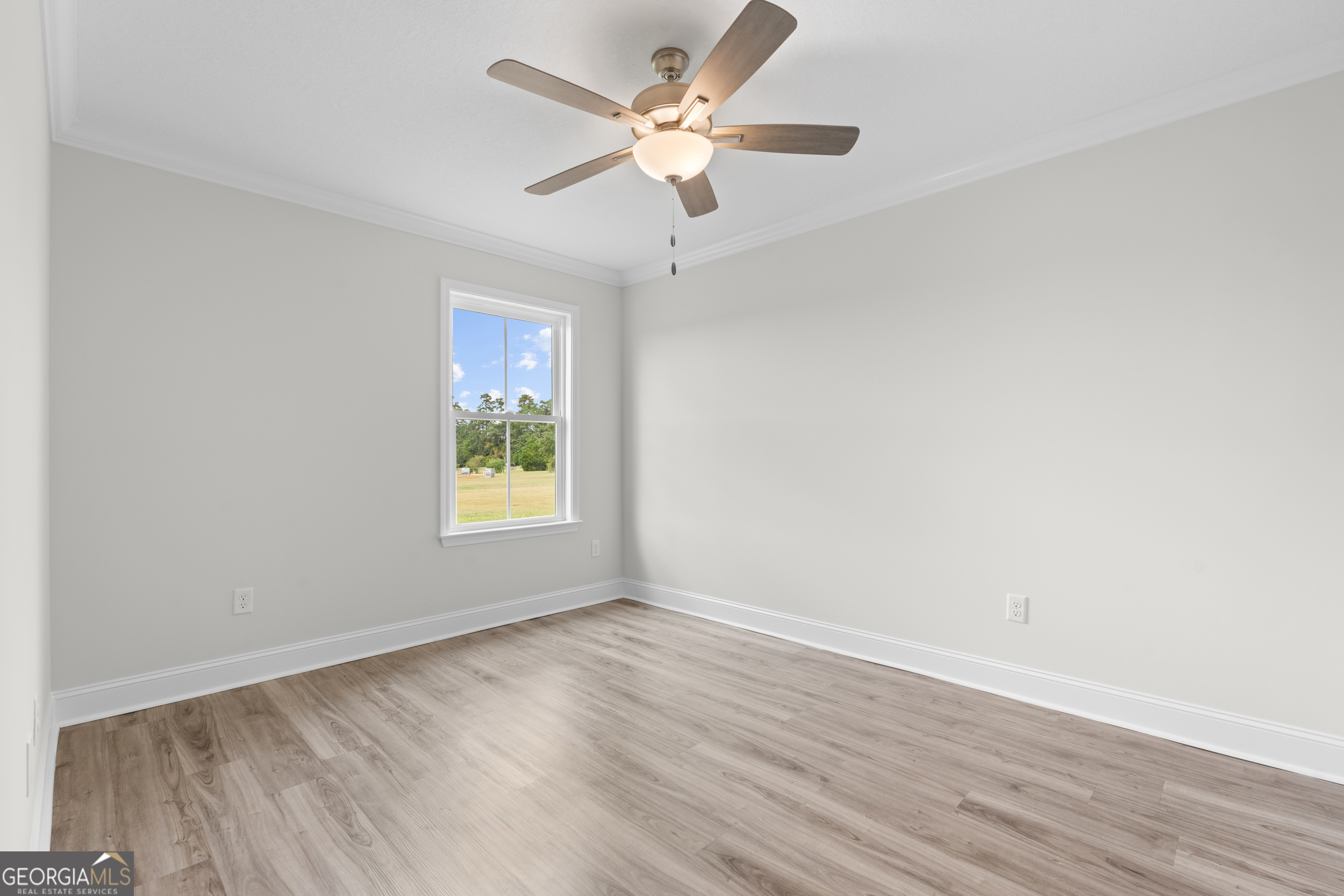 543 Jack Kennedy Road Statesboro, GA 30458 - Photo 15 of 35 a view of an empty room with wooden floor and a window