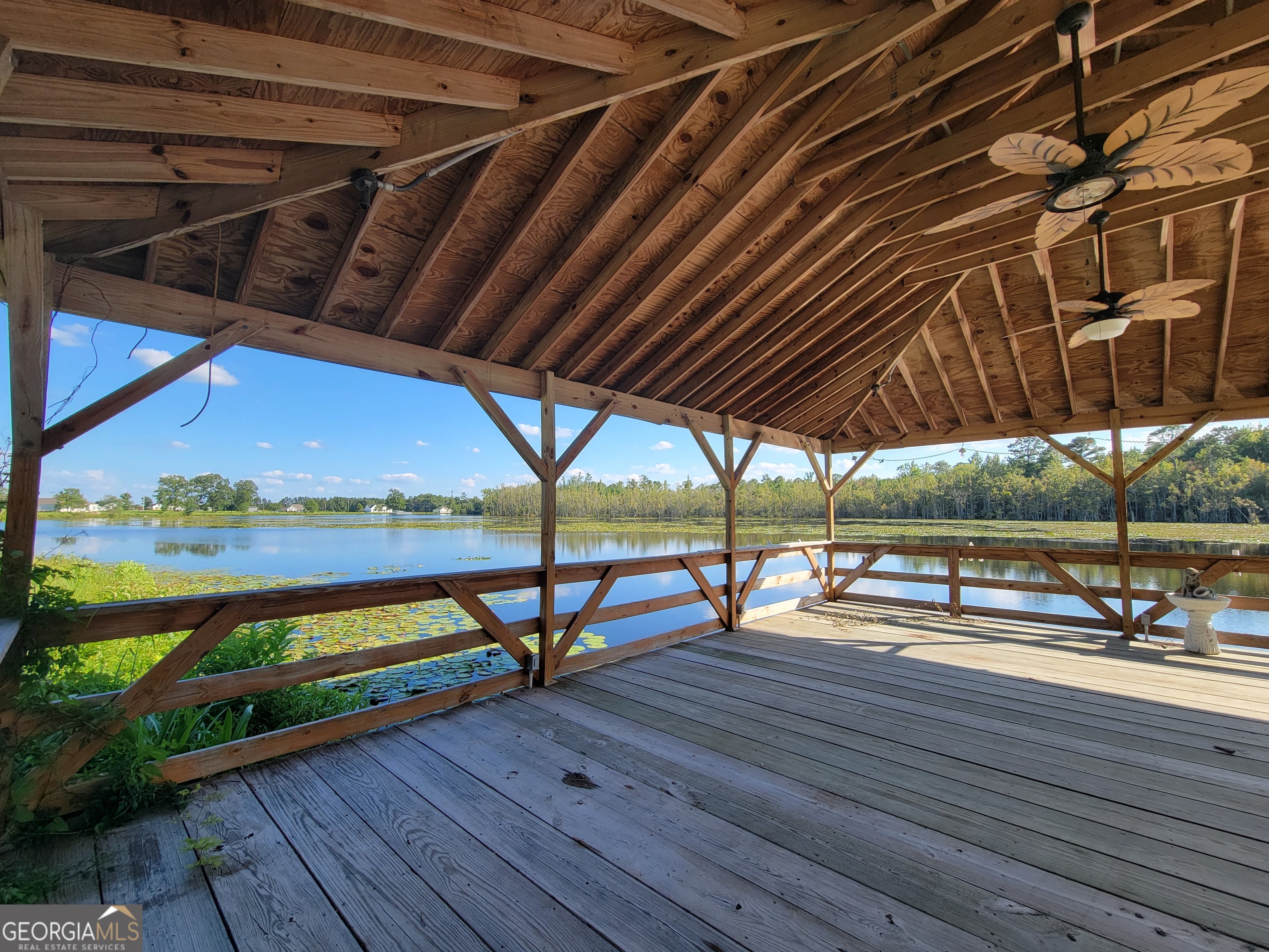 543 Jack Kennedy Road Statesboro, GA 30458 - Photo 34 of 35 a view of a swimming pool with a table and chairs under an umbrella