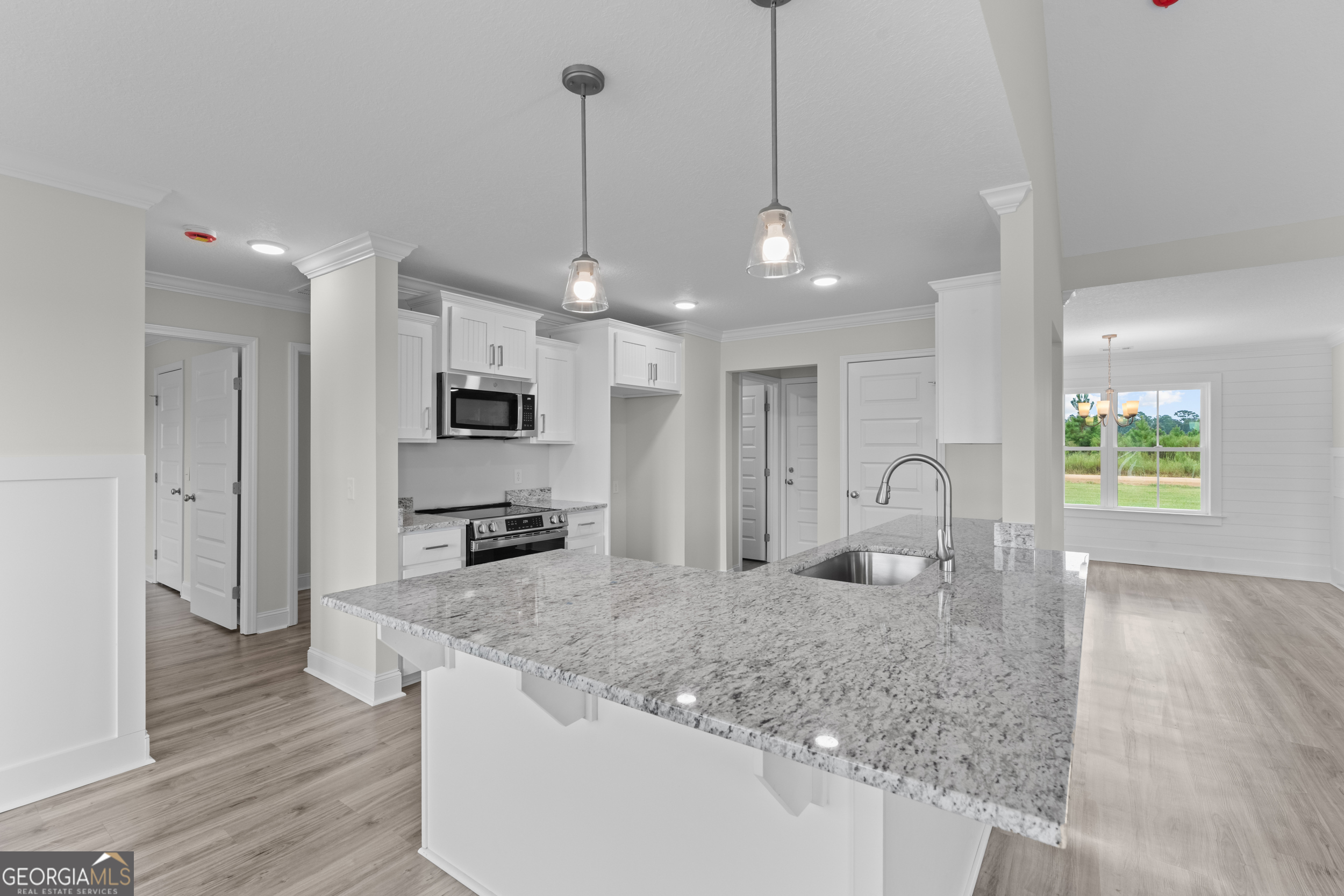 543 Jack Kennedy Road Statesboro, GA 30458 - Photo 7 of 35 a large kitchen with stainless steel appliances granite countertop a sink a stove and a wooden floors