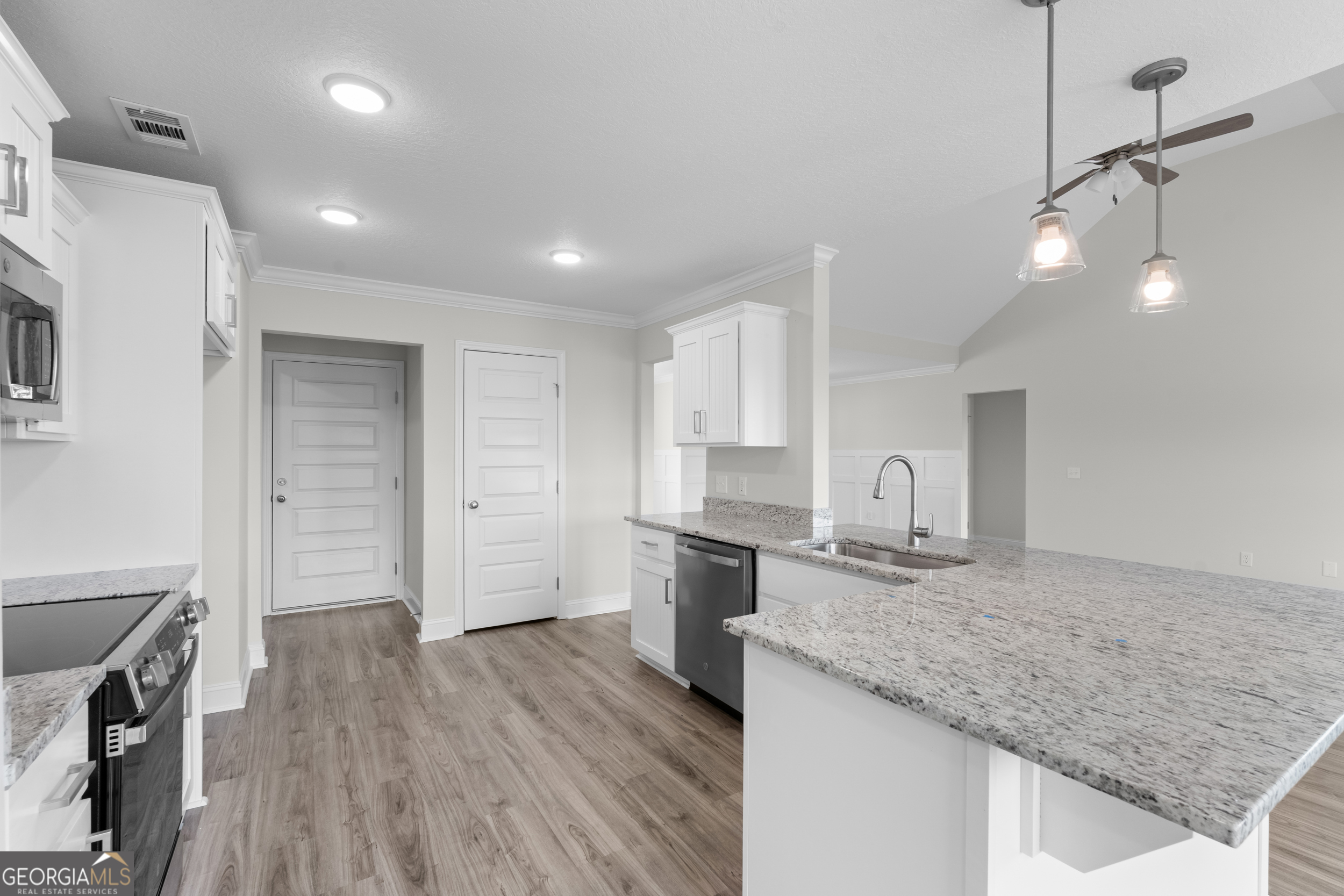 543 Jack Kennedy Road Statesboro, GA 30458 - Photo 9 of 35 a kitchen with a sink stove and cabinets