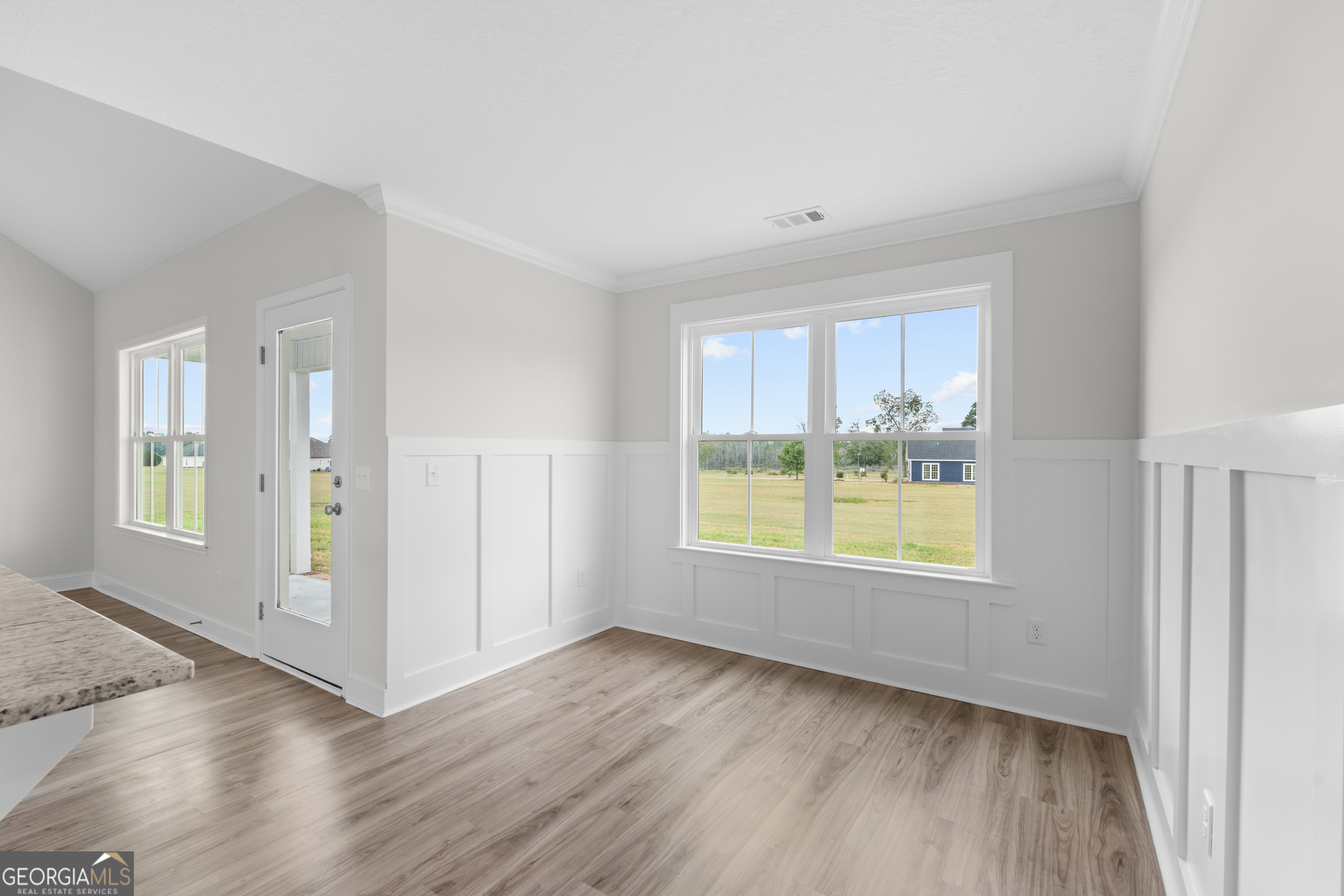 543 Jack Kennedy Road Statesboro, GA 30458 - Photo 10 of 35 a view of an empty room with a window and wooden floor