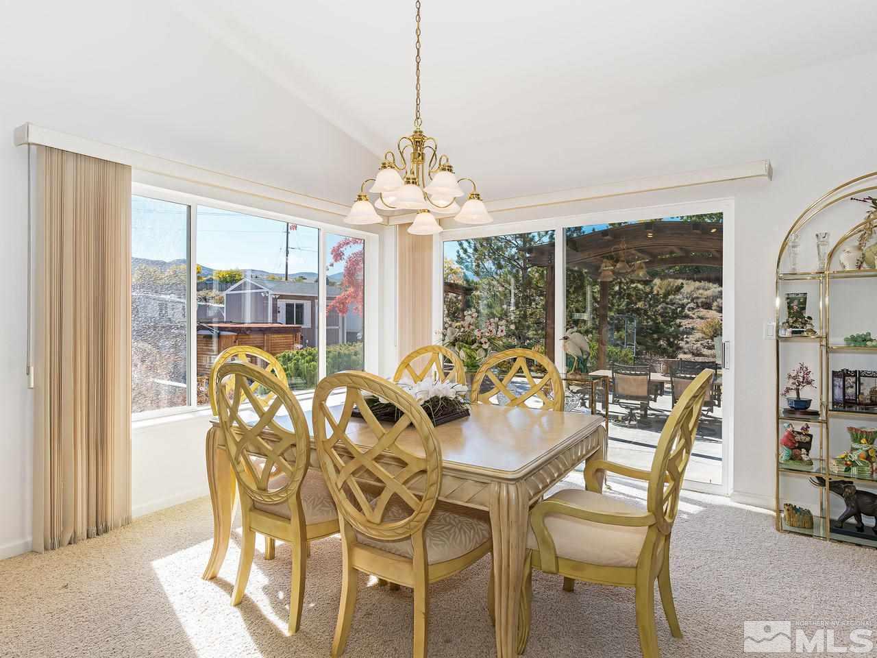 15523 Quicksilver Drive Reno, NV 89511 - Photo 6 of 25 a view of a dining room with furniture large windows and wooden floor