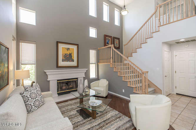 11218 Shadyridge Road Moorpark, CA 93021 - Photo 12 of 48 a living room with furniture a fireplace and a table
