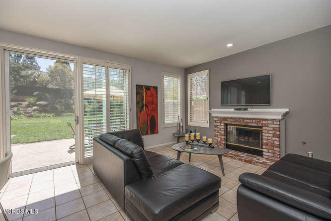 11218 Shadyridge Road Moorpark, CA 93021 - Photo 18 of 48 a living room with furniture a flat screen tv and a fireplace