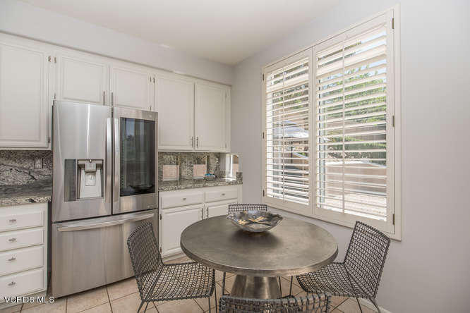 11218 Shadyridge Road Moorpark, CA 93021 - Photo 22 of 48 a kitchen with stainless steel appliances a dining table and chairs