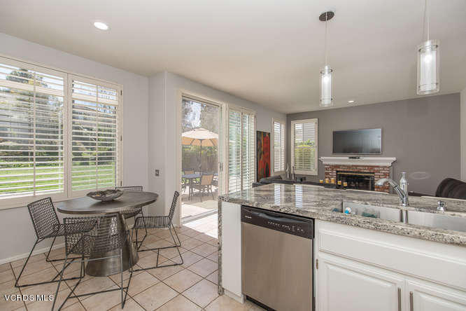 11218 Shadyridge Road Moorpark, CA 93021 - Photo 23 of 48 a kitchen with granite countertop a sink and chairs