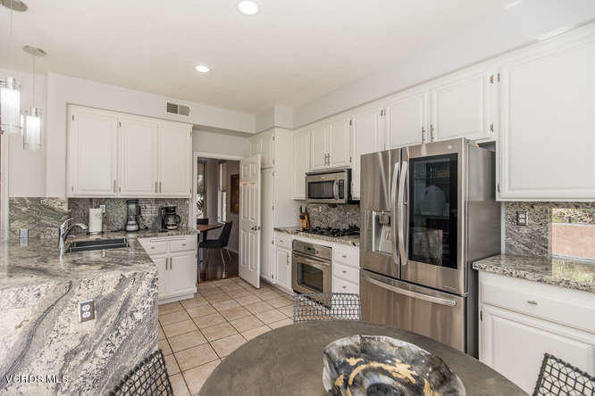 11218 Shadyridge Road Moorpark, CA 93021 - Photo 26 of 48 a kitchen with a refrigerator stove and sink