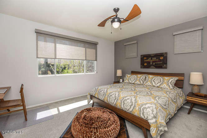 11218 Shadyridge Road Moorpark, CA 93021 - Photo 30 of 48 a bedroom with a bed a chandelier and a window