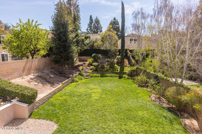 11218 Shadyridge Road Moorpark, CA 93021 - Photo 31 of 48 a view of a swimming pool with a bench and trees in the background