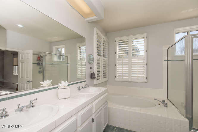 11218 Shadyridge Road Moorpark, CA 93021 - Photo 32 of 48 a bathroom with a granite countertop sink mirror and a bathtub