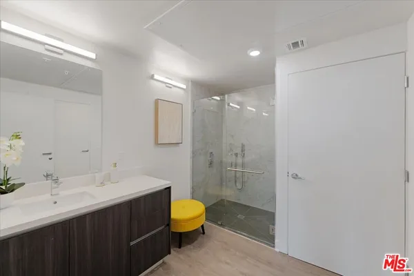 a bathroom with a double vanity sink toilet and shower