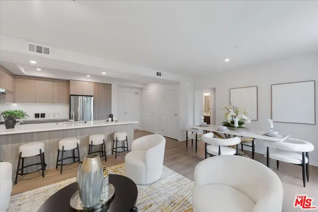 a large kitchen with a table and chairs