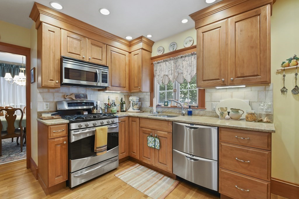 41 Peirce Street Arlington, MA 02476 - Photo 13 of 32 a kitchen with stainless steel appliances granite countertop a stove and a sink