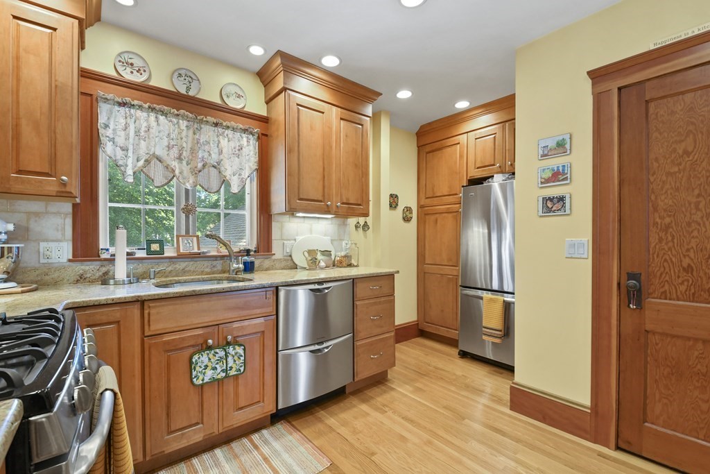 41 Peirce Street Arlington, MA 02476 - Photo 14 of 32 a kitchen with a refrigerator a sink and wooden cabinets