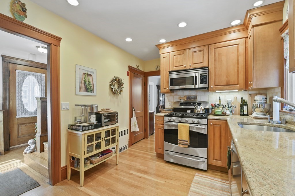41 Peirce Street Arlington, MA 02476 - Photo 15 of 32 a kitchen with stainless steel appliances granite countertop a stove a sink and a refrigerator
