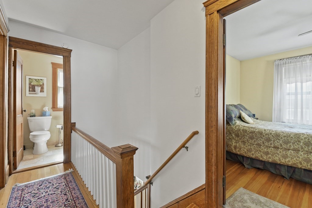 41 Peirce Street Arlington, MA 02476 - Photo 17 of 32 a view of a bedroom with wooden floor and a bedroom