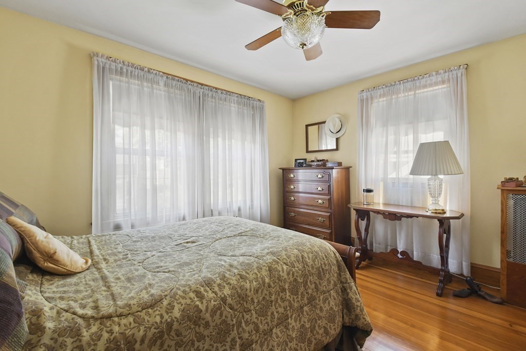 41 Peirce Street Arlington, MA 02476 - Photo 19 of 32 a bedroom with a bed and wooden floor