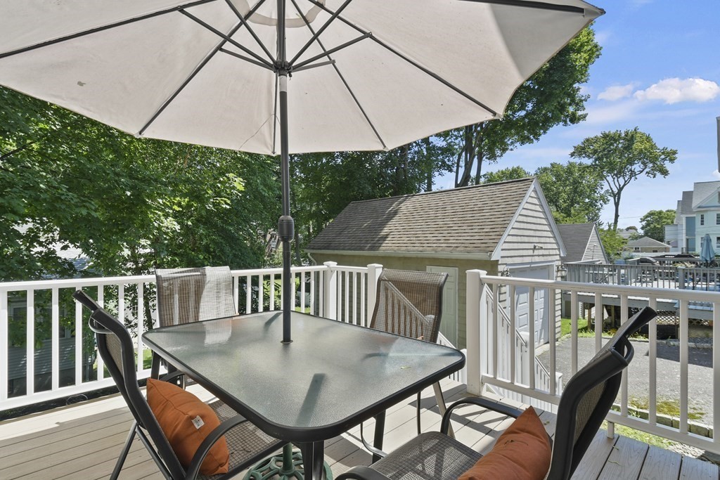 41 Peirce Street Arlington, MA 02476 - Photo 25 of 32 a balcony view with table and chairs under an umbrella