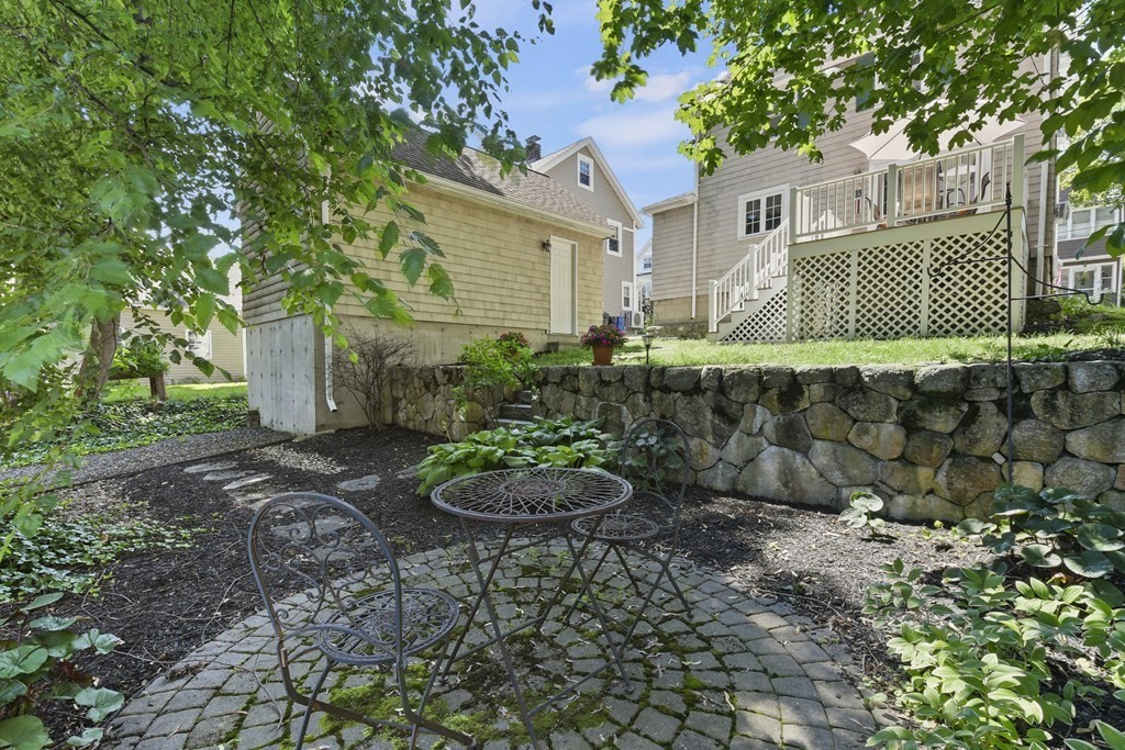 41 Peirce Street Arlington, MA 02476 - Photo 31 of 32 a view of a backyard with table and chairs and potted plants