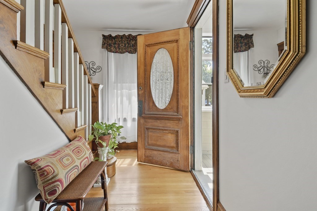 41 Peirce Street Arlington, MA 02476 - Photo 7 of 32 a view of a hallway with wooden floor and stairs