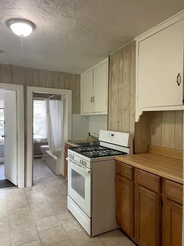 a kitchen with a stove top oven sink and cabinets