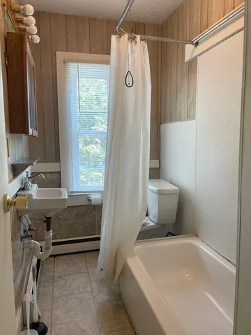 a bathroom with a sink a toilet and a shower