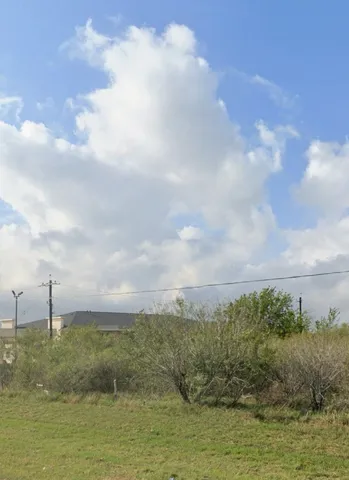 a view of a lake with houses in the back