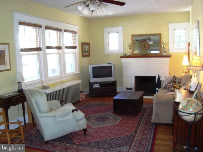 715 Murdock Road Baltimore, MD 21212 - Photo 2 of 17 a living room with furniture a flat screen tv and a fireplace