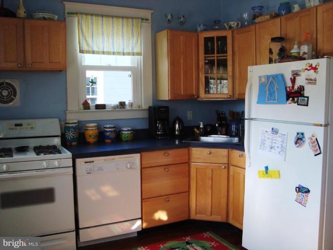 715 Murdock Road Baltimore, MD 21212 - Photo 5 of 17 a kitchen with stainless steel appliances a stove a microwave and cabinets