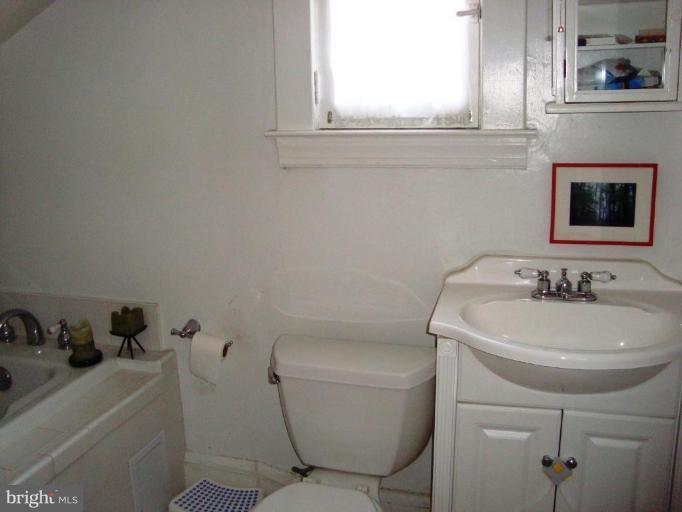 715 Murdock Road Baltimore, MD 21212 - Photo 9 of 17 a bathroom with a toilet sink and mirror