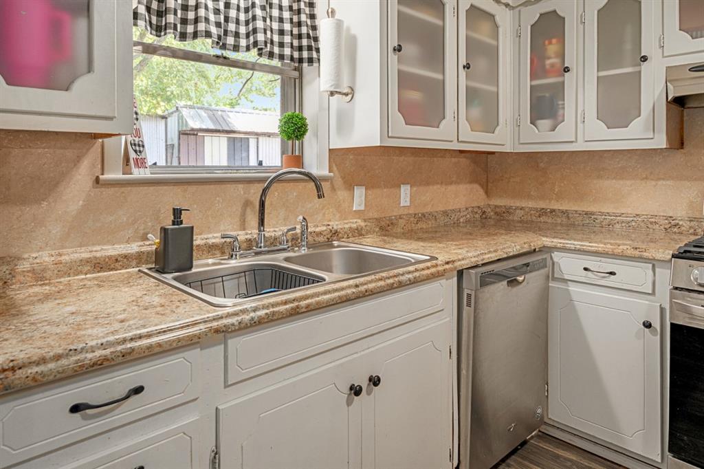 508 West 9th Street Kemp, TX 75143 - Photo 13 of 32 a kitchen with stainless steel appliances granite countertop a sink a stove and a granite counter tops with a window