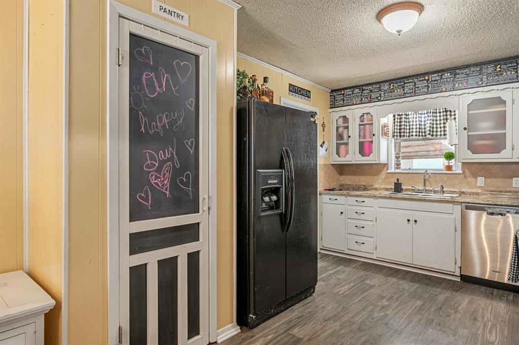 508 West 9th Street Kemp, TX 75143 - Photo 14 of 32 a kitchen with stainless steel appliances granite countertop a refrigerator and a sink