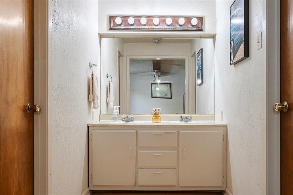 508 West 9th Street Kemp, TX 75143 - Photo 22 of 32 a bathroom with a sink mirror and vanity