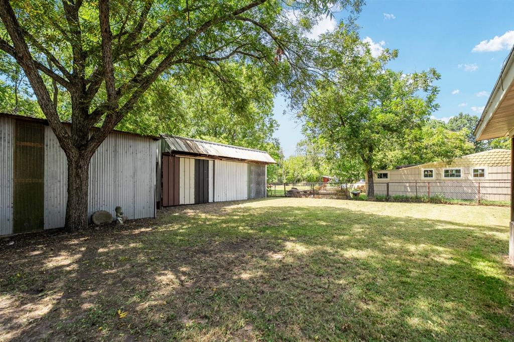 508 West 9th Street Kemp, TX 75143 - Photo 30 of 32 a view of a house with yard and a tree