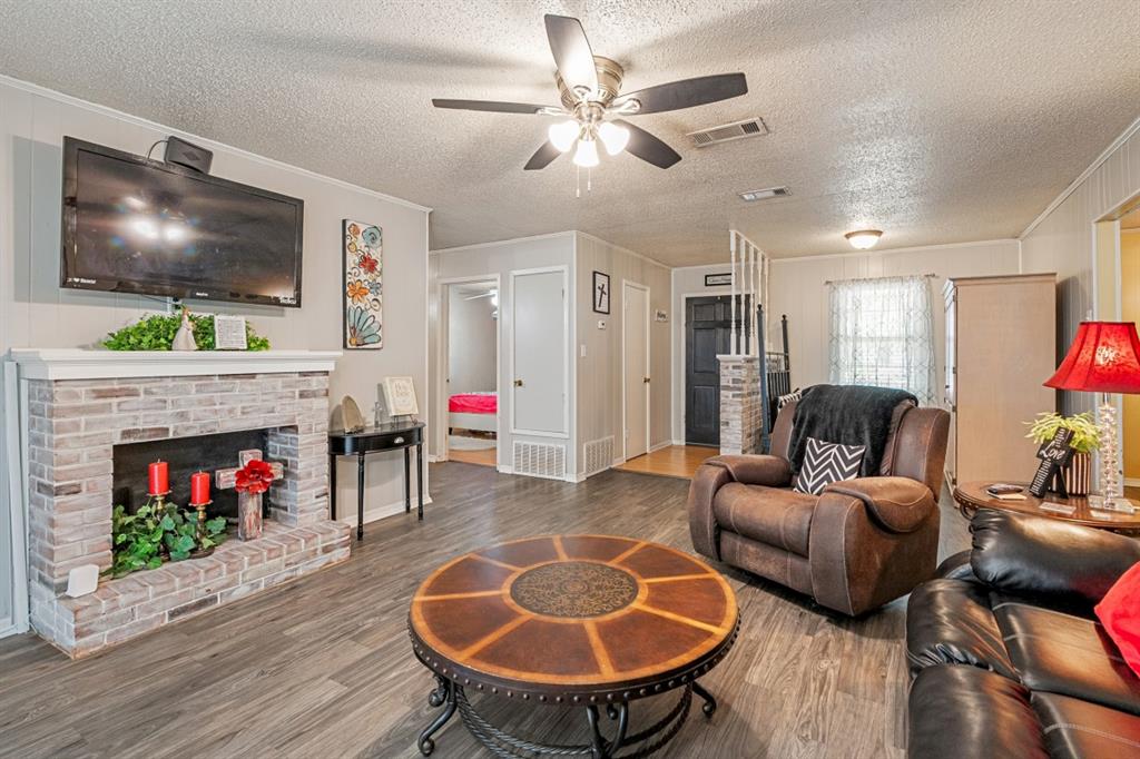508 West 9th Street Kemp, TX 75143 - Photo 3 of 32 a living room with furniture a flat screen tv and a fireplace