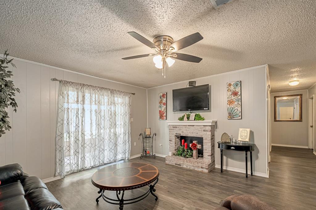 508 West 9th Street Kemp, TX 75143 - Photo 4 of 32 a living room with furniture a flat screen tv and a fireplace